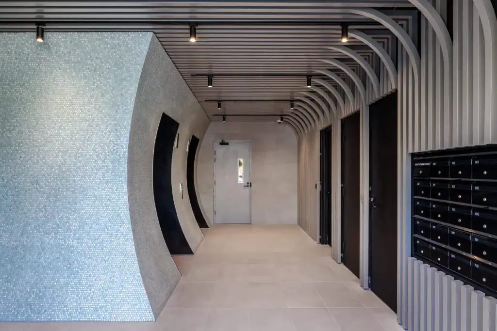 CED technician setting up access control and intercom in a Box Hill apartment corridor