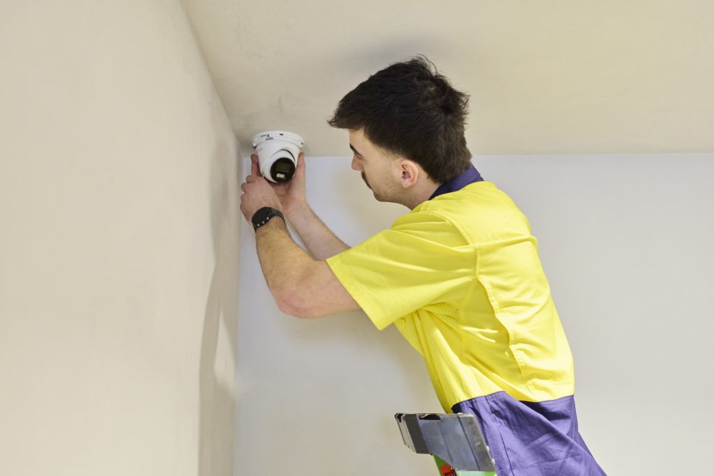 CED technician installing a CCTV camera at the Ringwood North dental practice
