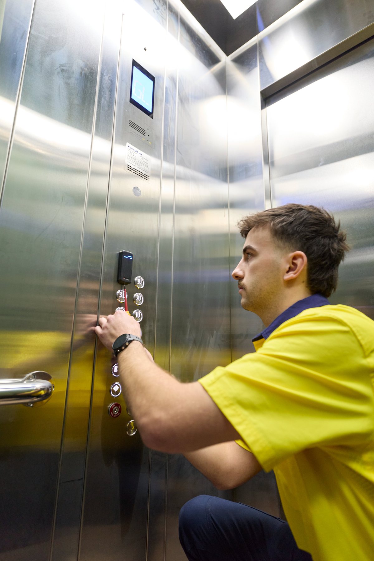 CED Security technician installing a card reader inside a lift